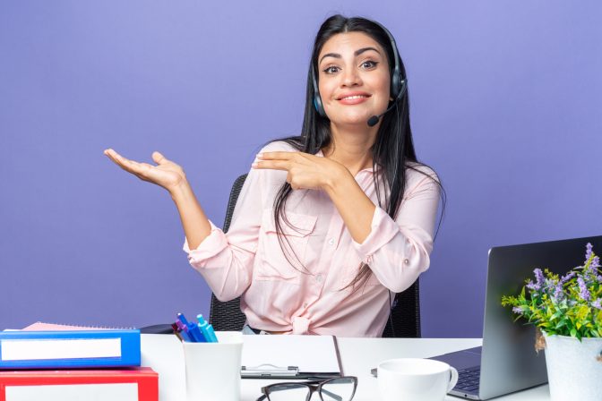 young beautiful woman in casual clothes wearing headset with microphone smiling presenting with arm of hand sitting at the table with laptop over blue background working in office SSUCv3H4sIAAAAAAAACpyRwW7DIAyG75P2DhHnRgpJFpa+SrWDA6xBpVAB6TRVffcZCBXn3fBn+7d/83h/axqygFecHJtHjDBWWm8+OAjKGsTdYedOGiFdTe5umLoaSKGCdQp0DRcIfDVwlQjNpnXEz5QkPkDYvPRx+o44BHlGjQxfEnnFU46bkkhJ7MAUIYeK+W1JrKAs/q/O/PgqbuAsDf9NC1dGnNQSspFTLiWXnyDdtbYGm1C2cnW3HHQsGCqlm1NcmXPVZsOazl7auN1McHGF1+ZEW3uDRccTf6OmLHwF77FcFF4N4vjJ9lrNMTYkA7sqEfgTMaRDP7FhmqYPyjrK+oHtBfn3VoU6aZ0ihDG/KFFbV3EDQjsxfNKOtwtbaDtyNrYwT7SdZzH2/Sh4zzge/vkHAAD//wMAbSp1FpgCAAA=